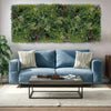 Image of Blue sofa with decorative pillows in a living room setting with a triptych green wall feature.