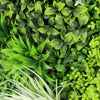 Image of Artificial forest floor greenery panel with various types of green plants close up