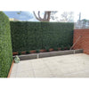 Image of Artificial Premium Natural Buxus Panel Installed On Patio Fence With Garden Bed in Front