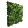 Image of side angle view of artificial green wall panel with various greenery on a white background