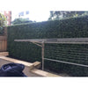 Image of Artificial Premium Natural Buxus Panel installed at a laundry area with the cloth drying rack