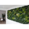 Image of Artificial Vertical Garden of Eden installed indoor on a white wall with table and chairs visible in the background