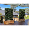 Image of two Artificial Vertical Garden of Eden walls sitting in wooden planter boxes on a balcony