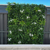 Image of Artificial White Tropics Vertical Garden Wall Panel installed on a colourbond fence
