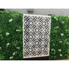Image of Artificial White Tropics Vertical Garden Wall Panel installed in between the patterned white geometric screen in a residential area