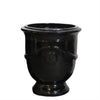 Image of Black medium ceramic planter with decorative ribbing on a white background