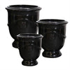 Image of Set of three black ceramic urn-shaped planters on a white background