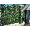 Image of Image of a man installing the Double Sided Artificial Ivy Roll 3m x 1m Screen on a fence outdoors