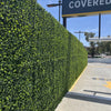 Image of Artificial Jasmine Hedge Plant Wall Screen Panels lining a concrete driveway at a covered parking entrance in an industrial setting