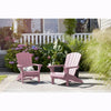 Image of Two pink Adirondack chairs on a patio with plants and flowers in the background.