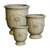 Image of Three sand beige ceramic french urns with decorative elements on a white background