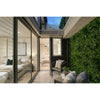 Image of Artificial White Oasis Vertical Garden Panel installed on the wall of a patio featuring a seating area just outside a modern bedroom visible through large glass doors