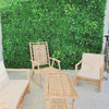 Image of Artificial White Oasis Vertical Garden Panel installed on a large outdoor wall in a patio setting with wooden chairs and a table