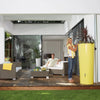 Image of Modern outdoor living space with people sitting on a sofa and a yellow 350L Color 2in1 MiniTank planter.