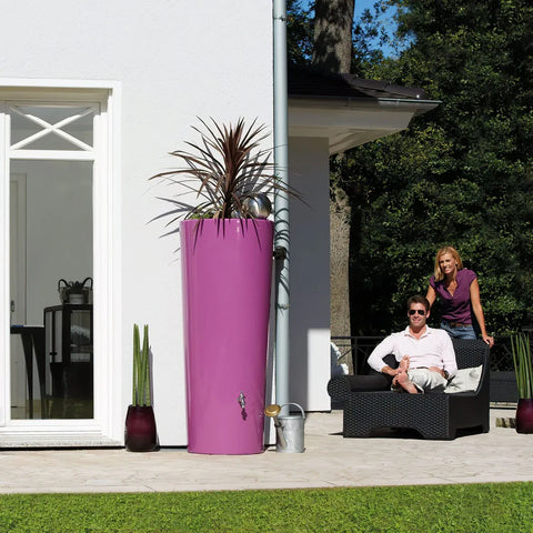 Purple cylindrical 2in1 MiniTank with a plant on a patio with people sitting nearby.
