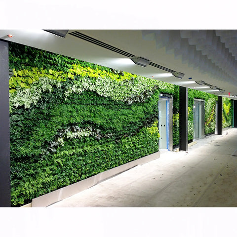 Green living wall in an indoor setting with a modern architectural background
