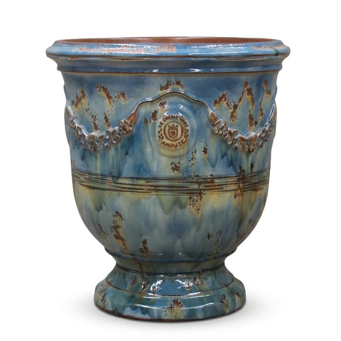 Blue ceramic planter with decorative patterns on a white background