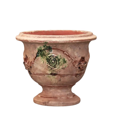Terracotta pot with decorative elements on a white background