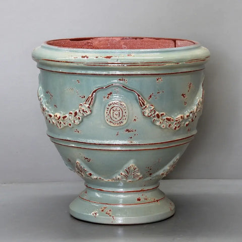 Decorative ceramic vase with intricate designs on a gray background