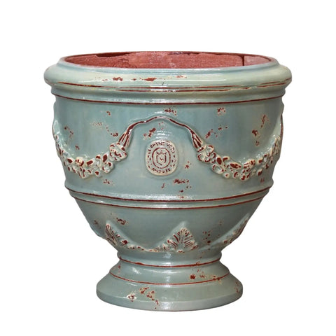 Decorative ceramic planter with floral patterns on a white background