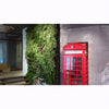 Image of Red telephone box next to a living wall in an indoor setting