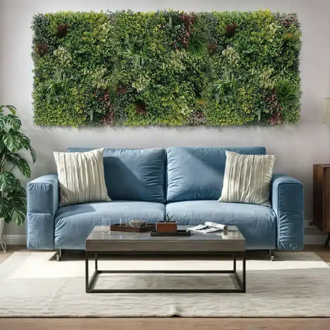 Blue sofa with decorative pillows in a living room setting with a triptych green wall feature.