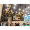 Image of Artificial Green Forest Vertical Garden Panel Installed in a Coffee Shop behind the staff serving area
