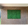 Image of Artificial Mixed Boxwood 1m x 1m Plant Panel UV Stabilised mounted on a red brick wall  in a covered outdoor or patio area