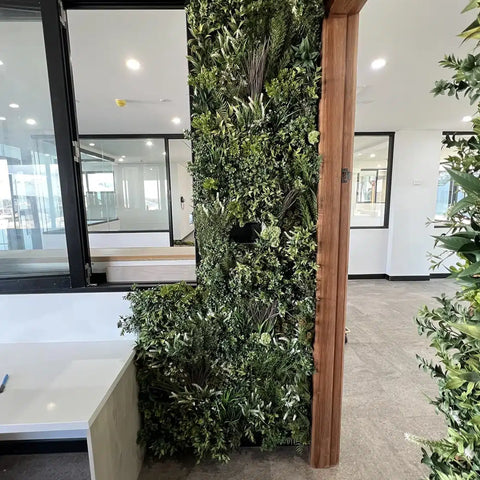 Artificial Vertical Garden of Eden Installed indoors next to a door frame and a window