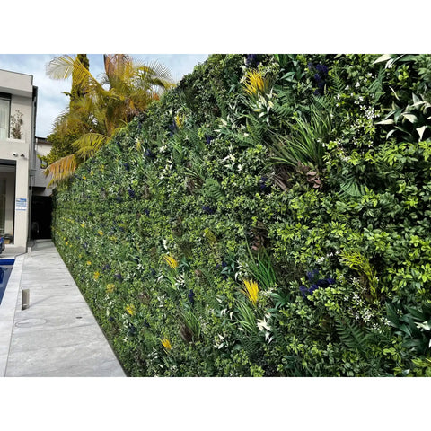 Artificial Vertical Garden of Eden Installed Outdoors on a fence in a residential swimming pool area with a concrete walkway
