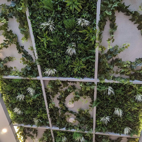 Detailed close up image of Artificial White Grass & Fern Wall Panel installed on a ceiling ceiling with lights and elegant borders