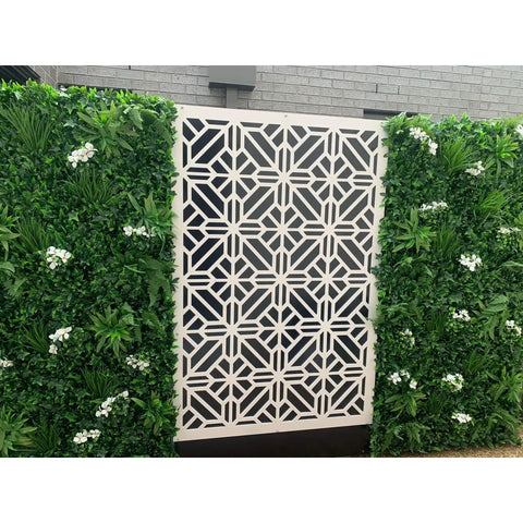 Artificial White Tropics Vertical Garden Wall Panel installed in between the patterned white geometric screen in a residential area
