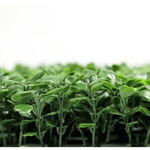 A close up side view of the Artificial Boxwood Hedge Plant Wall Screening Panel highlighting its dense, three dimensional foliage against a clean white background