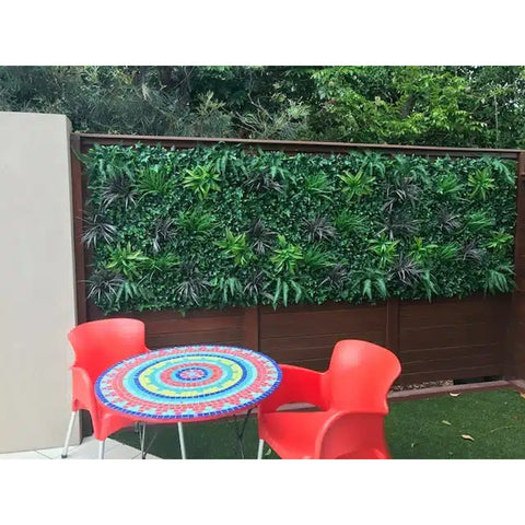 m x 1m UV Stabilised Coastal Greenery Artificial Vertical Garden Panel installed wooden fence in an outdoor setting with tables and chairs