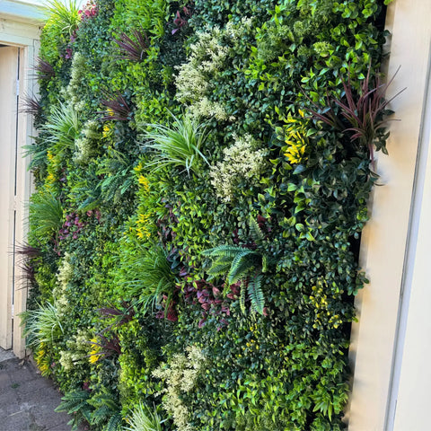 Evergreen Rainforest Recycled Artificial Green Wall installed on a sturdy frame beside a door