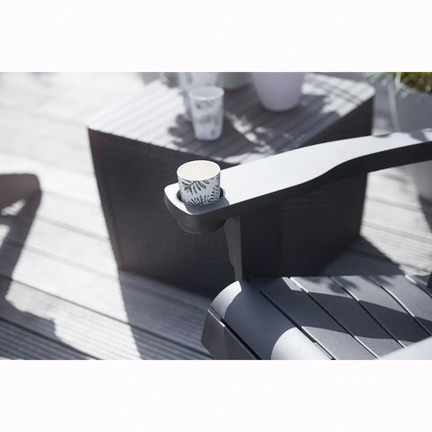 Black chair with a cup holder on a wooden deck