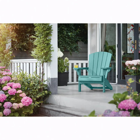 Teal Adirondack chair on a porch with flowers and plants.