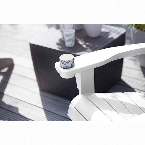 White chair with a cup on a wooden deck