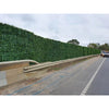 Image of Artificial Laurel Hedge Panels installed alongside a highway acting as a visual and sound barrier behind a guardrail 
