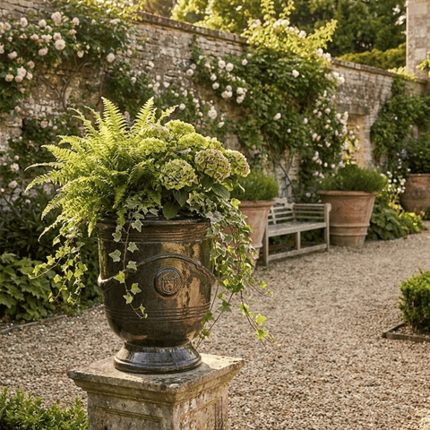 Saphire french anduze urn on a pillar in a beautiful european garden