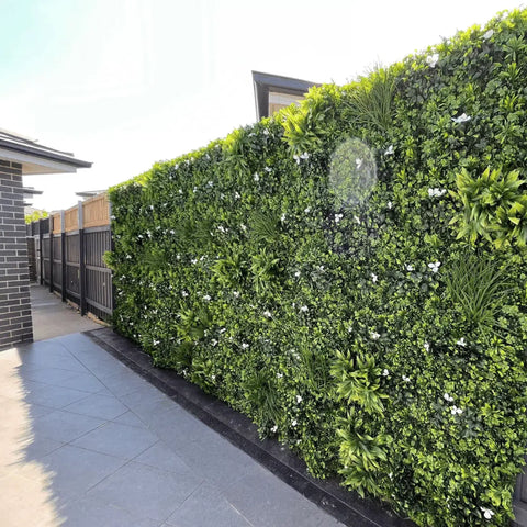 Artificial White Oasis Vertical Garden Panel installed on a colourbond fence along a residential tiled walkway