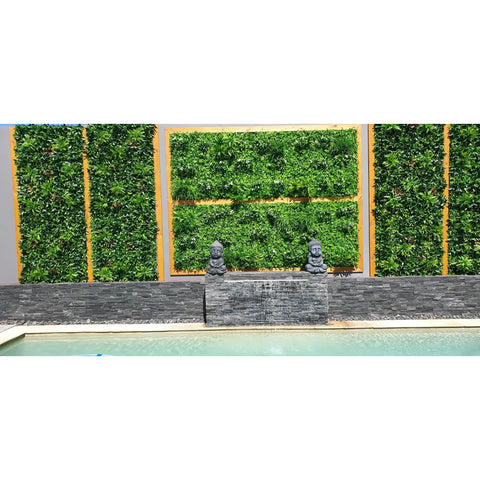 Artificial White Oasis Vertical Garden Panel installed on a concrete wall with wooden accents styled with figurines and displayed beside a swimming pool
