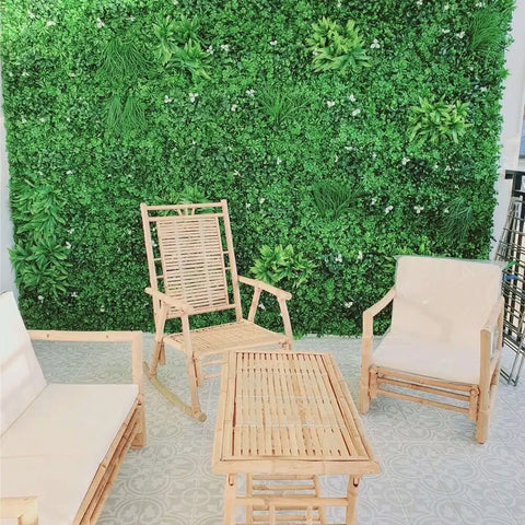 Artificial White Oasis Vertical Garden Panel installed on a large outdoor wall in a patio setting with wooden chairs and a table