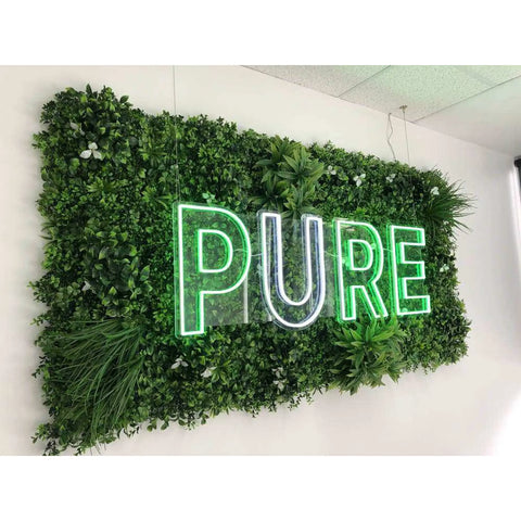 Artificial White Oasis Vertical Garden Panel with LED letter lights mounted on to a white wall